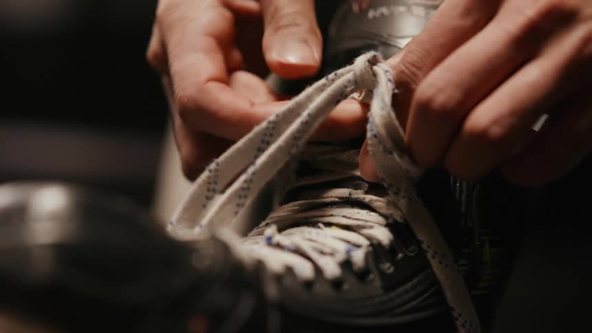 A clip of a person lacing their ice skates