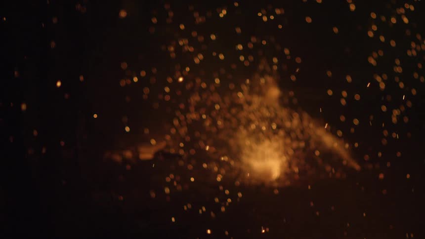 Sparks floating in the sky and small branches burning