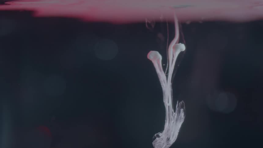 White liquid moves in a vat of water