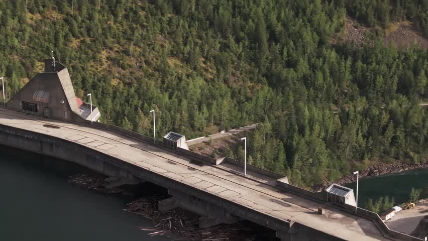 Birds eye view of a hydro electric dam a forest landscape in the background