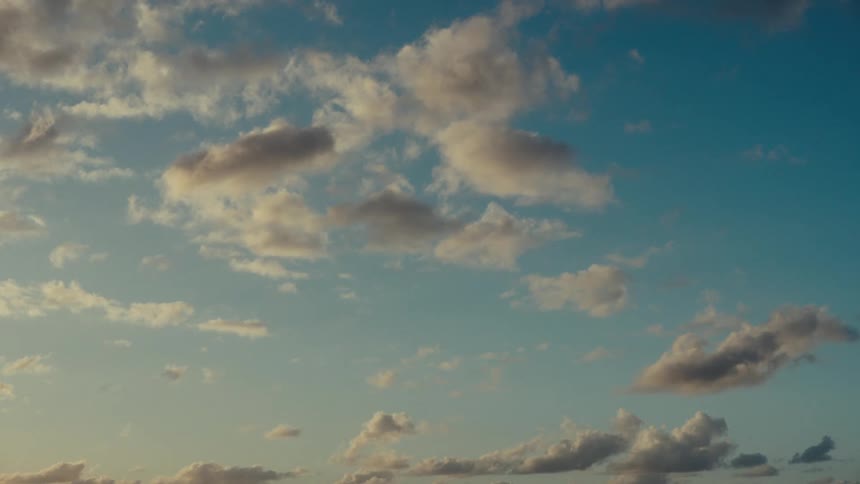 Clusters of clouds move slowly in the sky