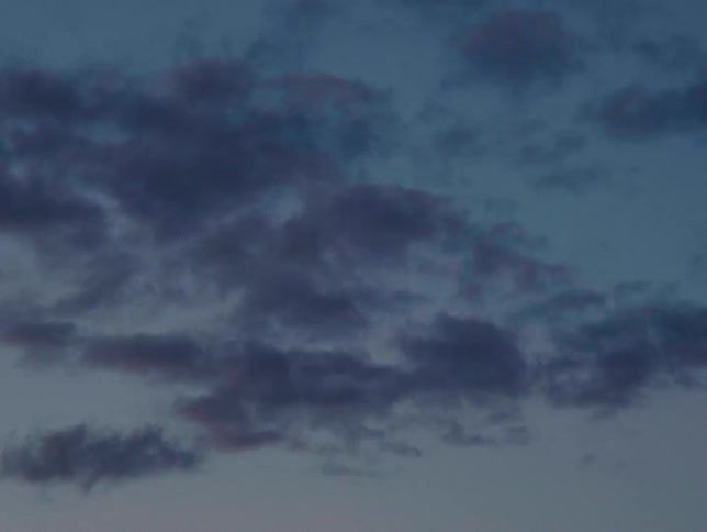 Clusters of clouds moving slowly across the sky