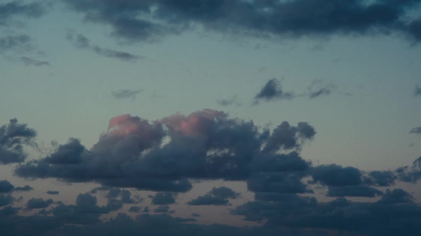 The sky at dusk with a large stormy cloud formation