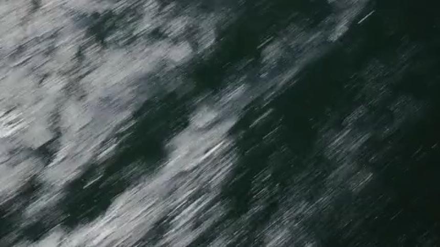 FPV aerial of the city and water racing by
