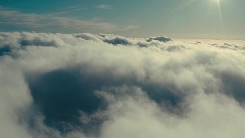 Sky landscape with sun flare and dense clouds