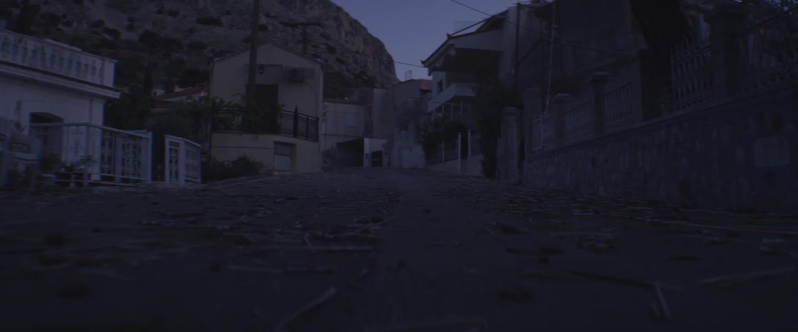 A darkened alley near a rocky hill