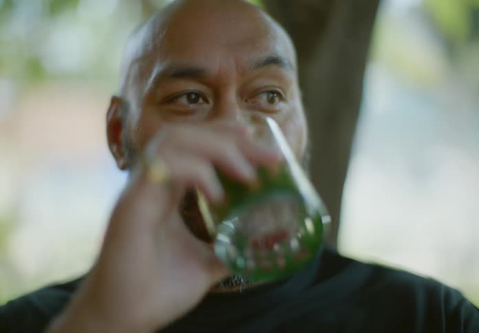 Portrait of a bearded man drinking a glass of water