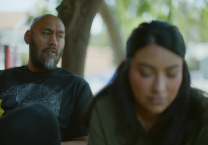 A man and a woman having a conversation outdoors