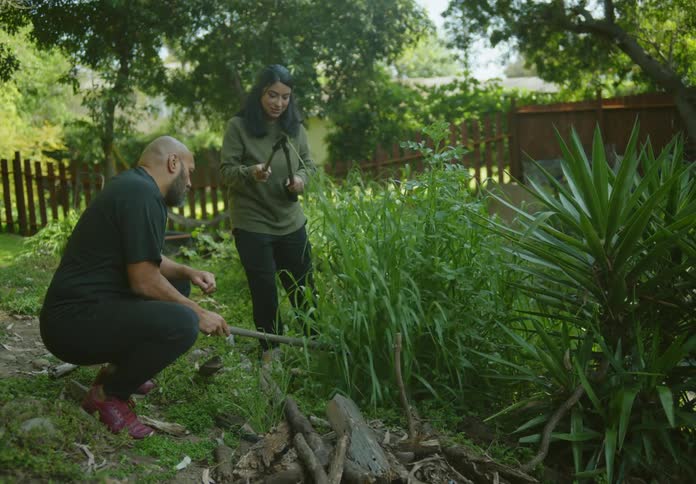 A man and woman are gardening together