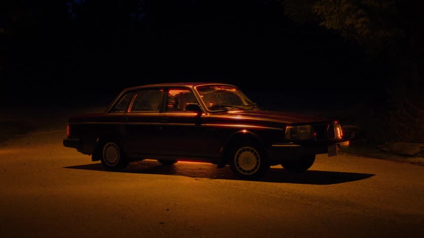 A car is parked on the dark road