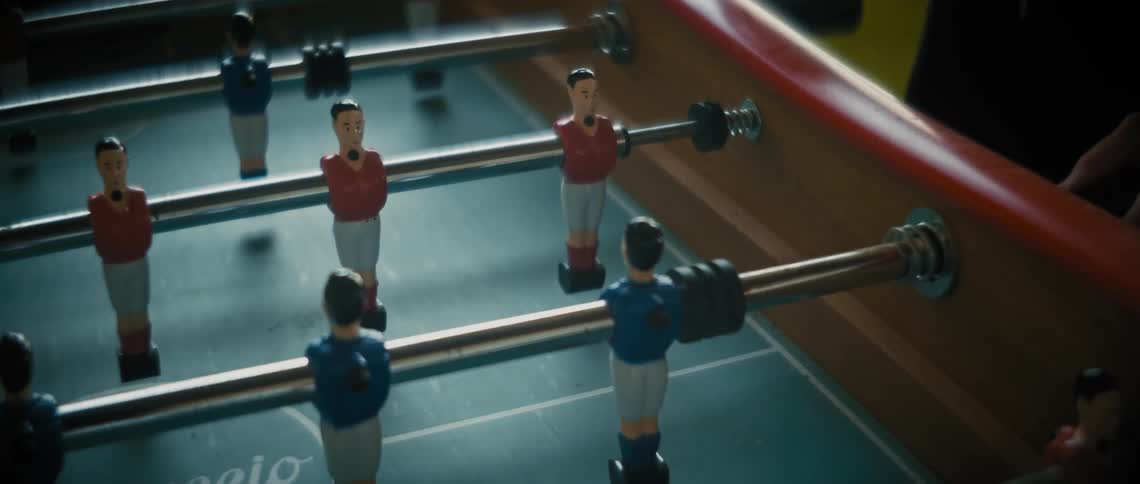 People play a game of table football