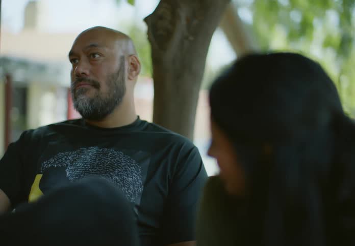 A man and woman talk outside