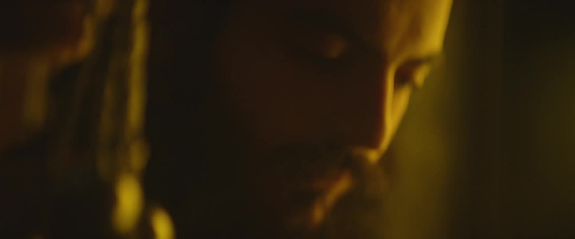 Bearded man looking down at something