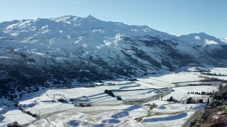 Aerial view of snowcovered mountain peaks against a cloudy sky