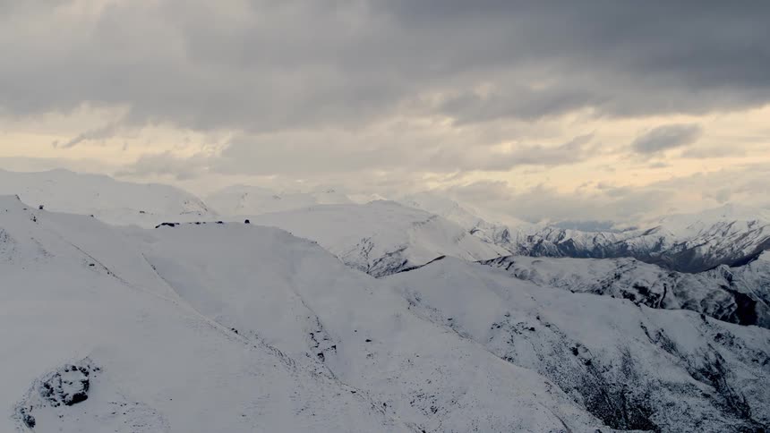 A scene of a mountain range covered with snow