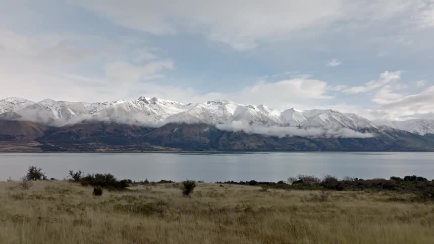 The mountain past the lake is covered with snow
