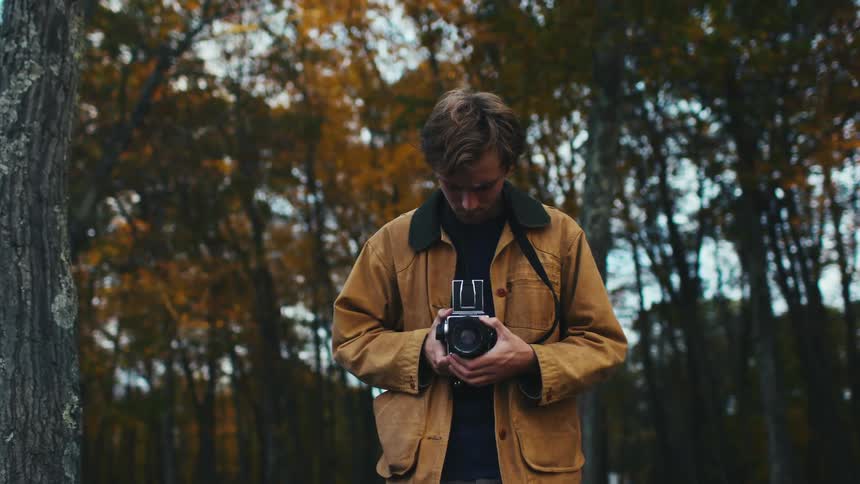 A young man takes a photograph on a Hasselblad