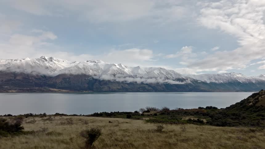 Tranquil landscape with a large lake and mountains in the background