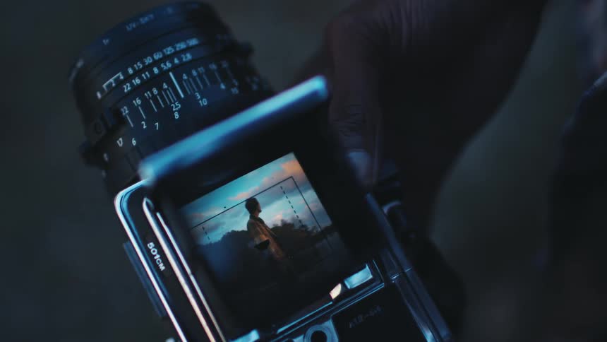 A man photographs his friend on a Hasselblad medium format camera