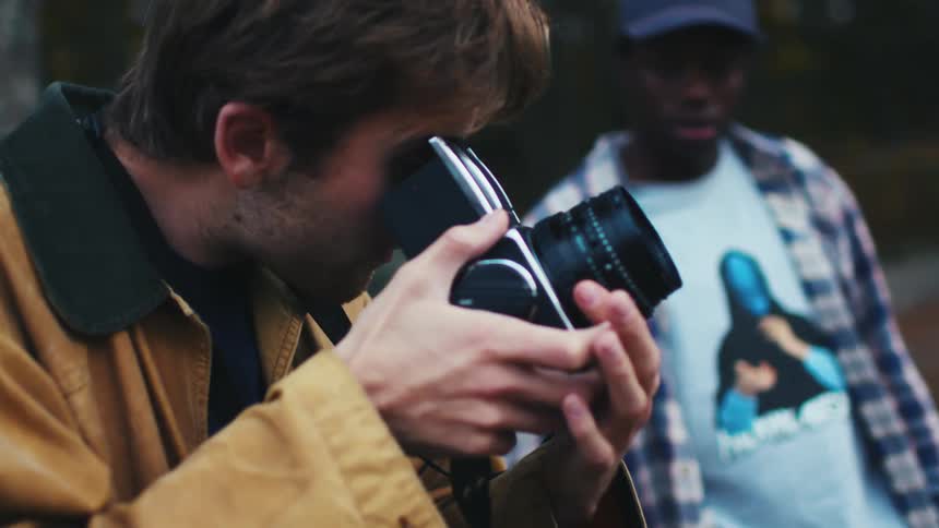 Two young artists take photographs of nature