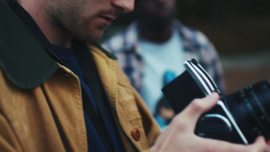 A man is taking photographs with a camera