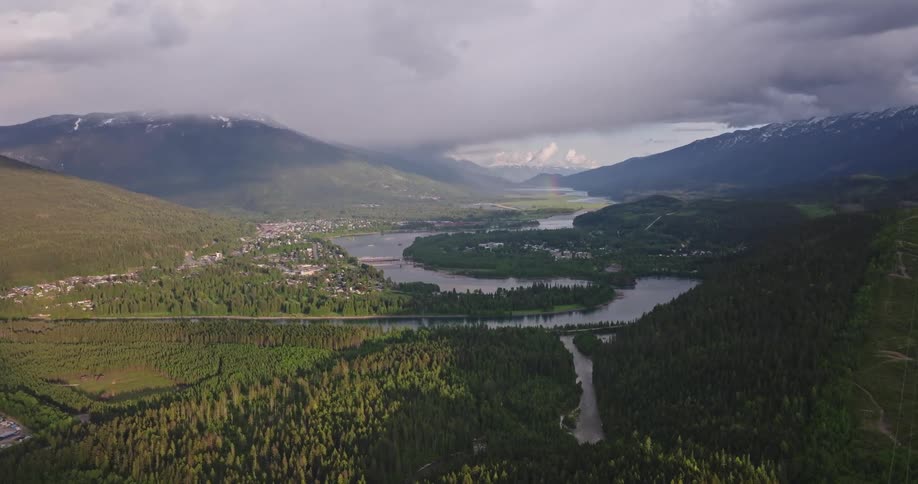 An aerial clip of a river in a woody mountainous area