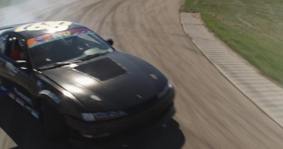 Black car doing a drift maneuver on a track