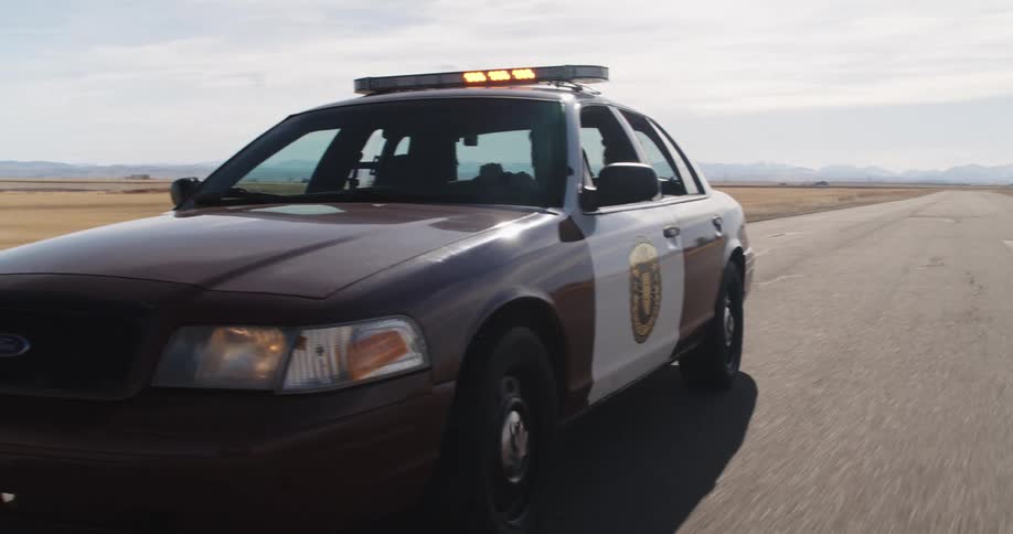 Police car moving on a road with its lights activated