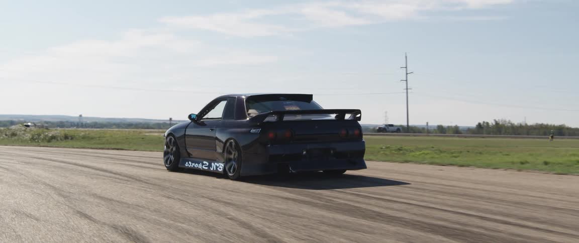 Black sports car moving on a track
