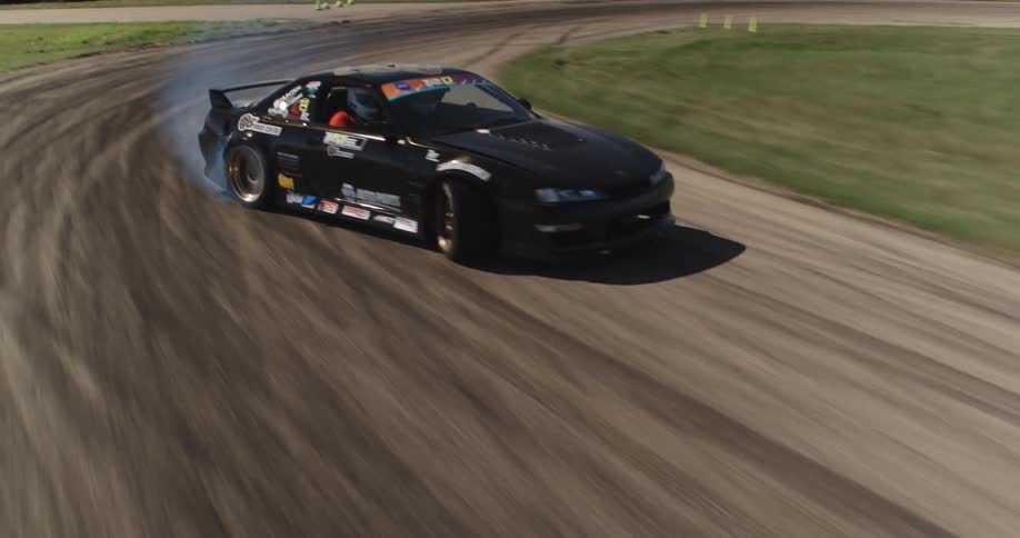 Moving black sports car skidding on a track