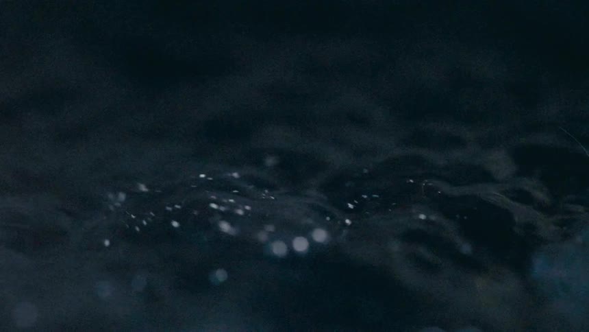Water flows and bubbles as the sun reflects on the surface