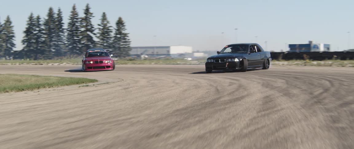 Two cars are drifting on the track