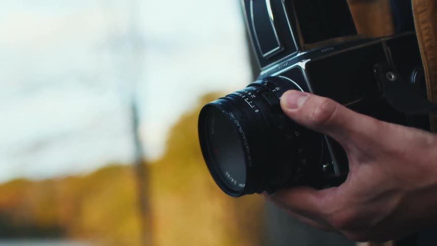 A man focuses a Hasselblad camera