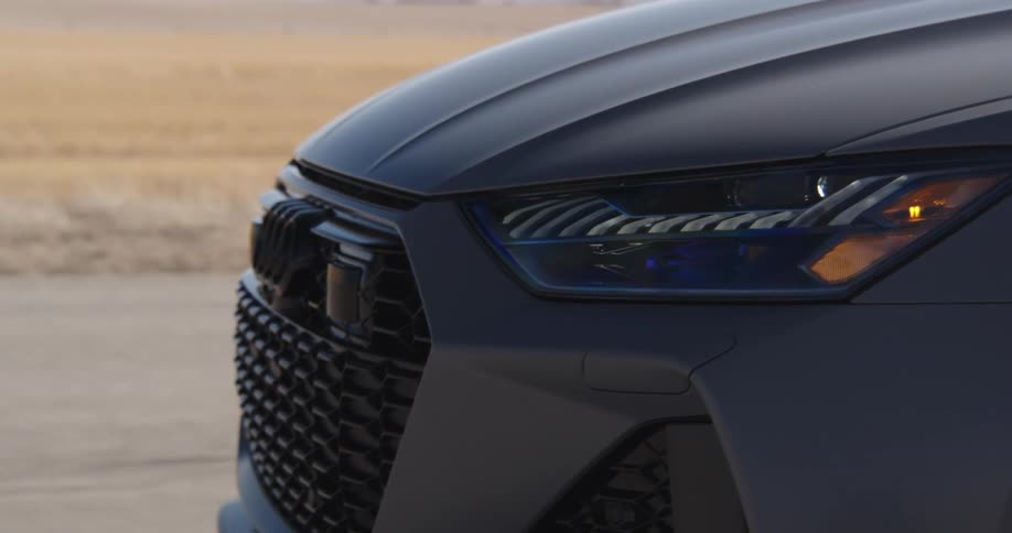 Close up of a cars front driving on a road in the desert