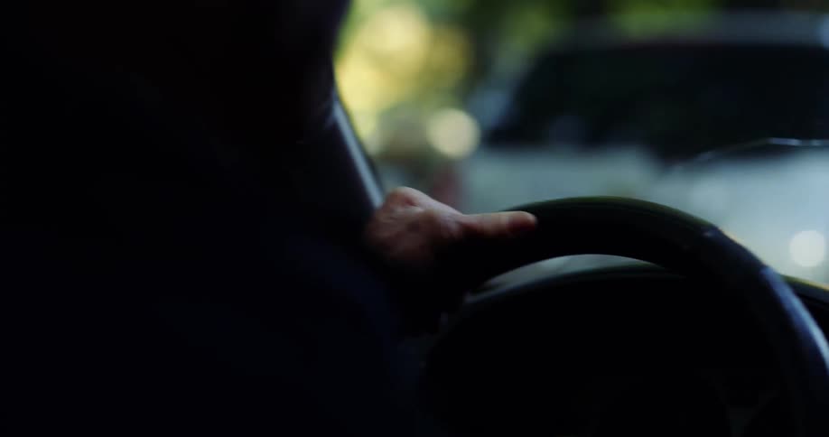 Driver steers vehicle with cracked windshield past other vehicles