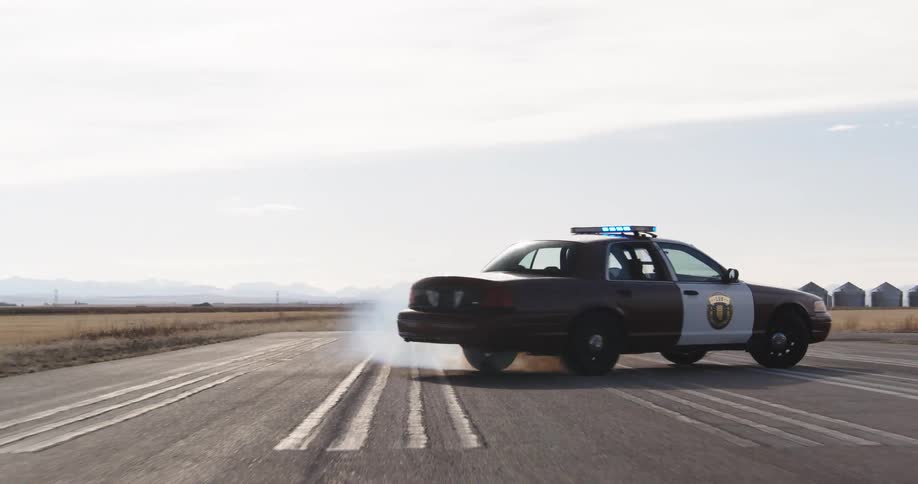 A police car drifting on an asphalt road
