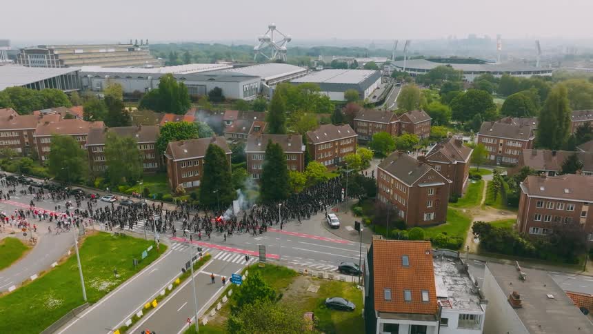 A large group of protesters marching through a suburb