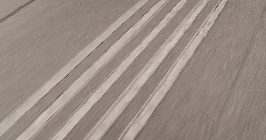 Gray sports car moving on a straight track