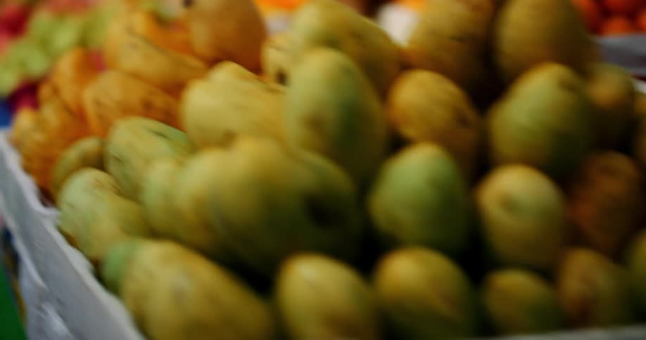 In a supermarket the aisle with all of the fruits and vegetables is being scurried down