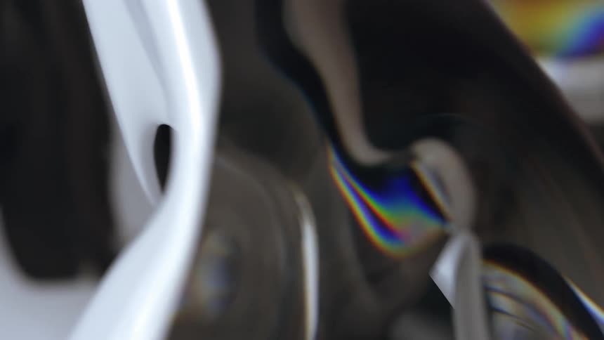 A rippling fluid reflecting black and white objects around it