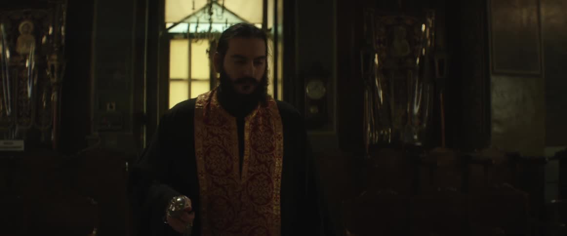 A religious man walks through a church
