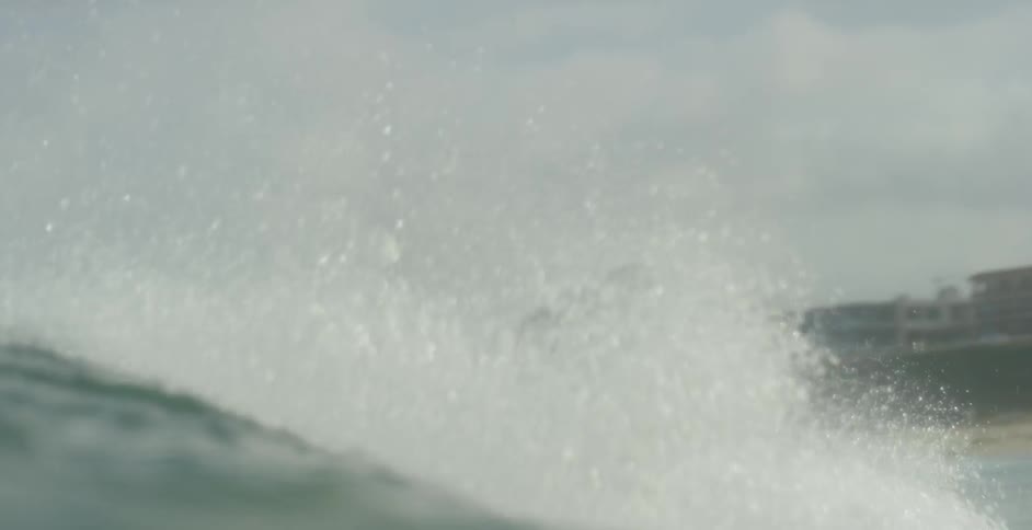 Surfer riding a medium-sized wave  as seen from a water level view