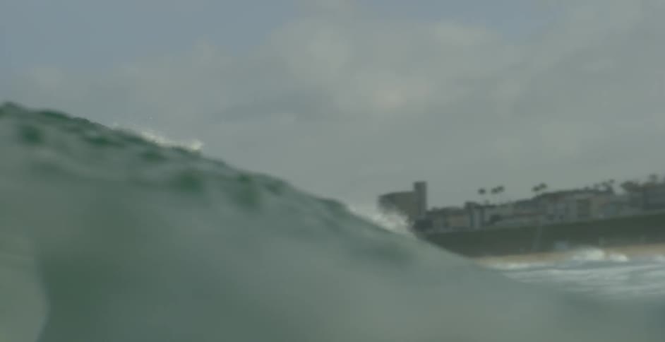 A man is surfing on a wave