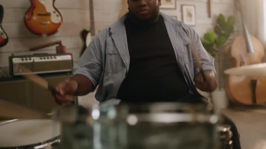 Man playing drums indoors