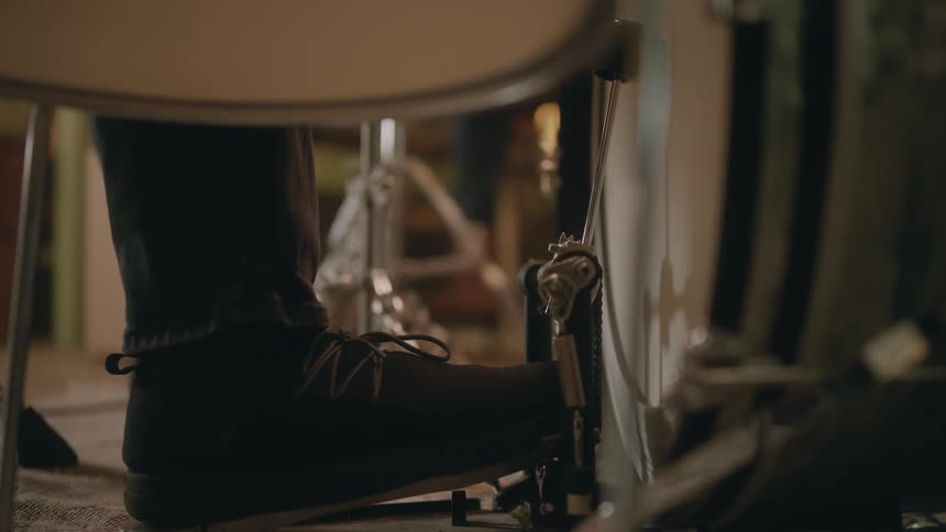 A drummer uses his foot to play a bass drum