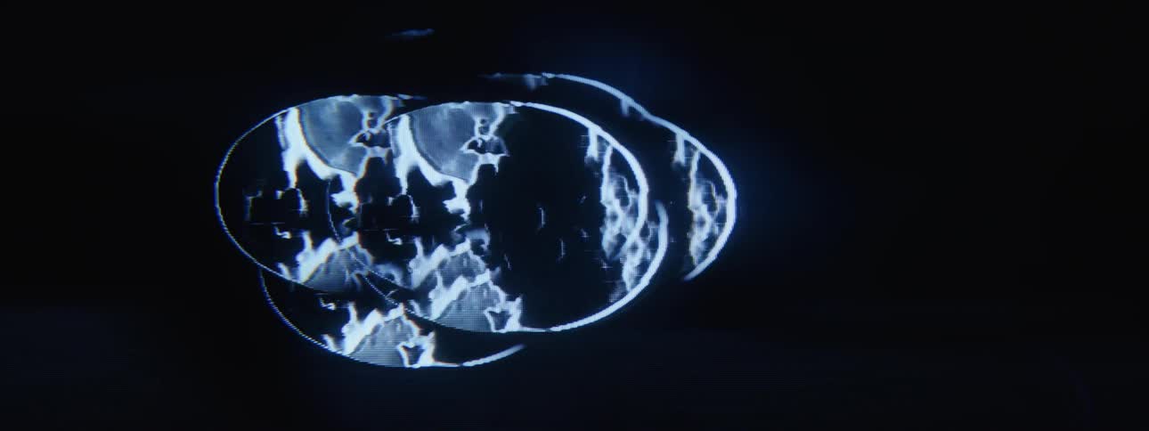 Light effects play through oval shapes against a black background