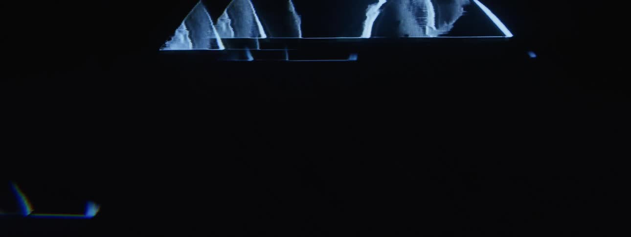 A graphic consisting of distorted triangles moves up a screen