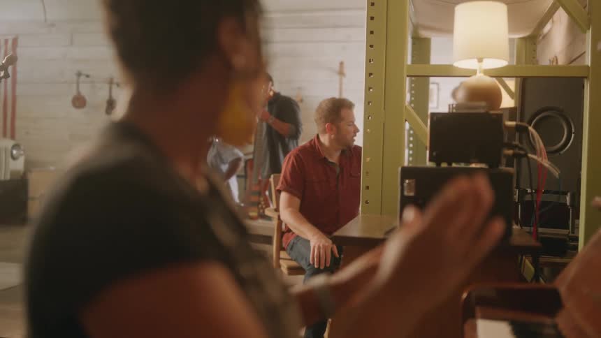 A black woman speaks to her bandmates before playing the piano