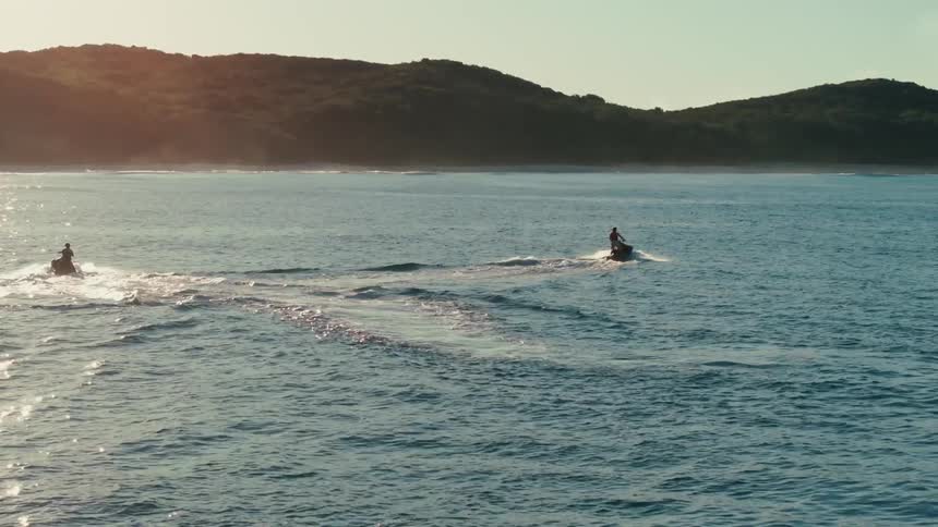 A footage of two people riding on a jet ski