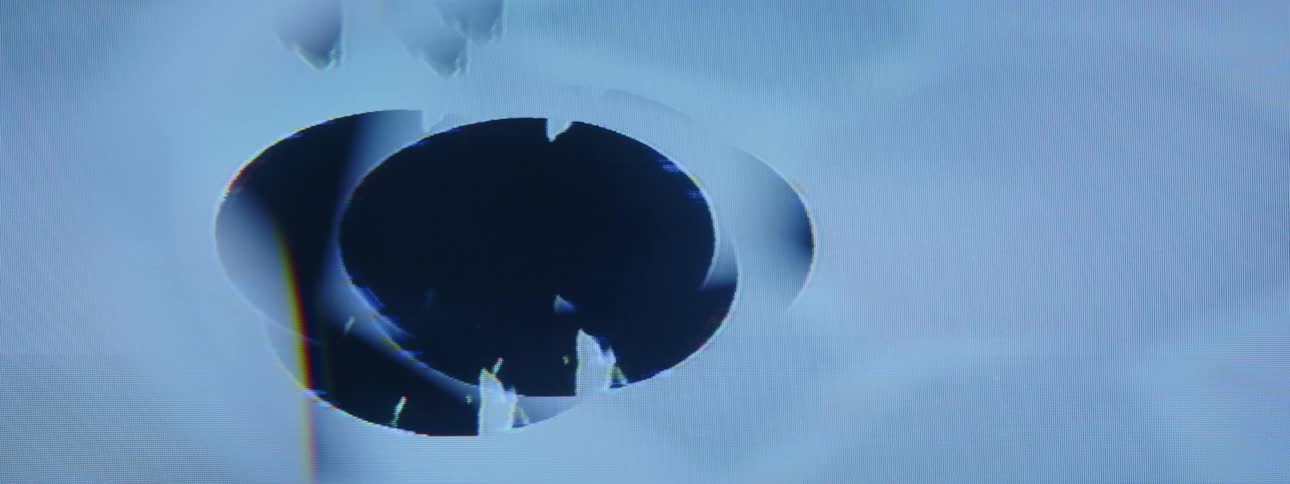 The graphic is of a black hole with objects falling in